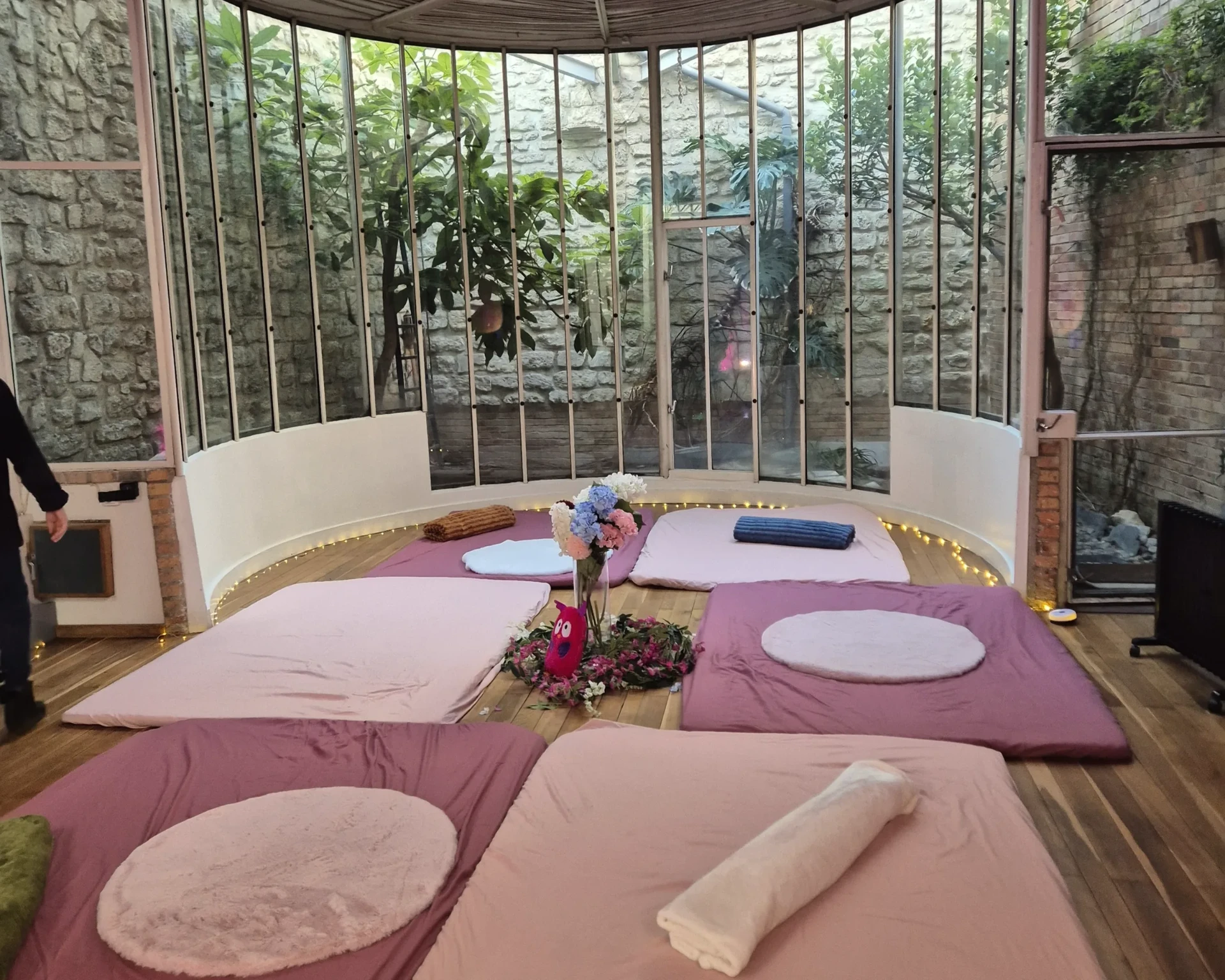 la pièce préparée : futons, coussins ronds, un bouquet posé au centre